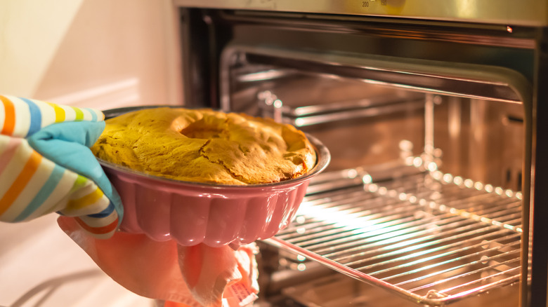 bundt cake being pulled from oven 