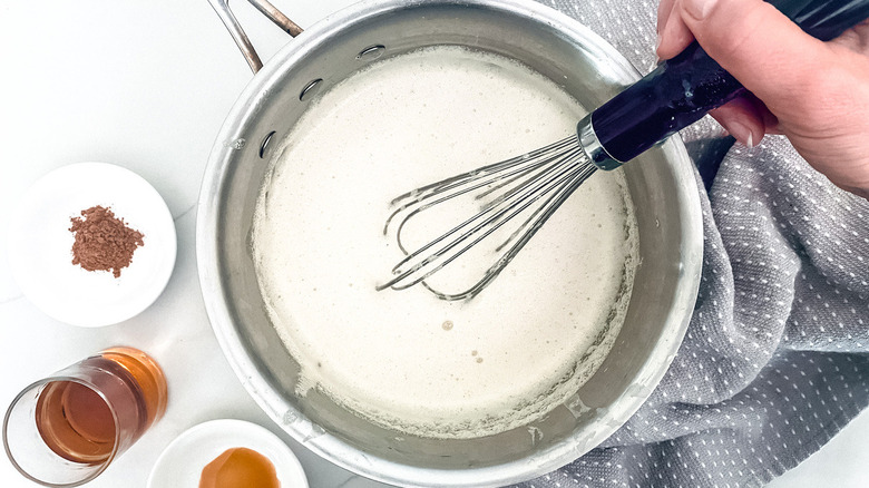 whisk and saucepan 