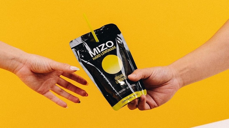 Hand reaching for MIZO pouch