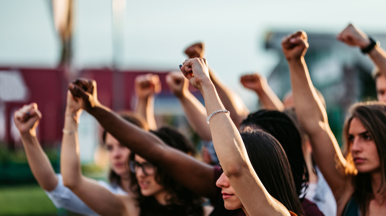 protestors raising fists above their heads