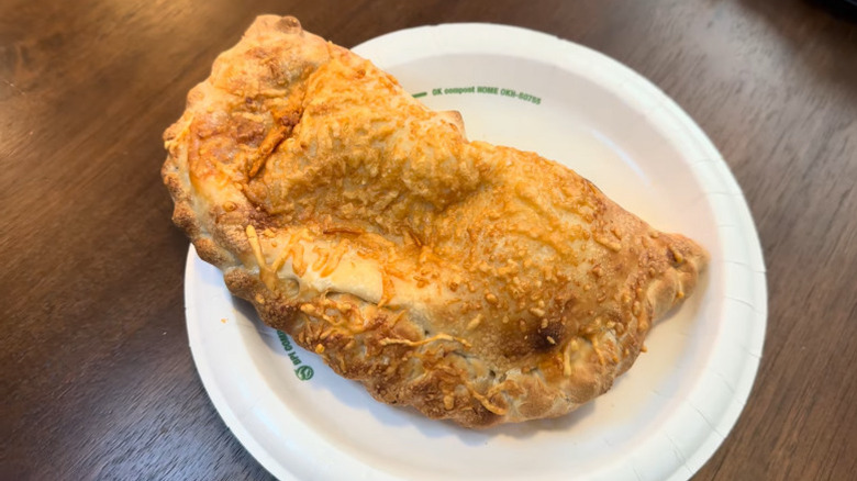 a Costco combo calzone on a paper plate