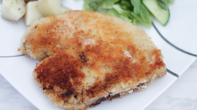 breaded pork chop on plate