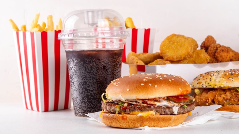 Fast food burgers, fries, chicken sandwich, nuggets, and soda