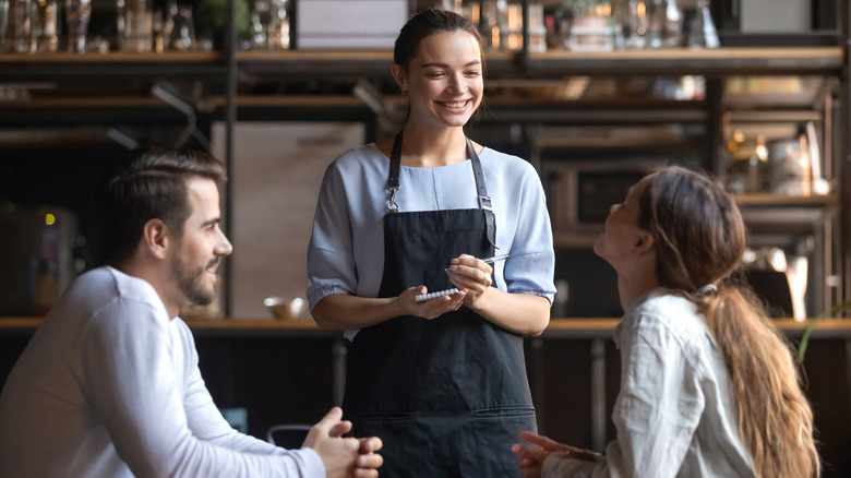 Waitress taking a couples' order at a restaurant