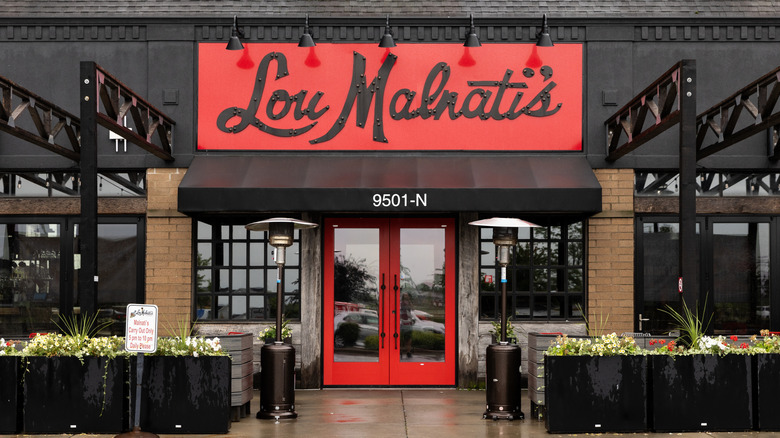 an exterior view of a Lou Malnati's with red and black signage