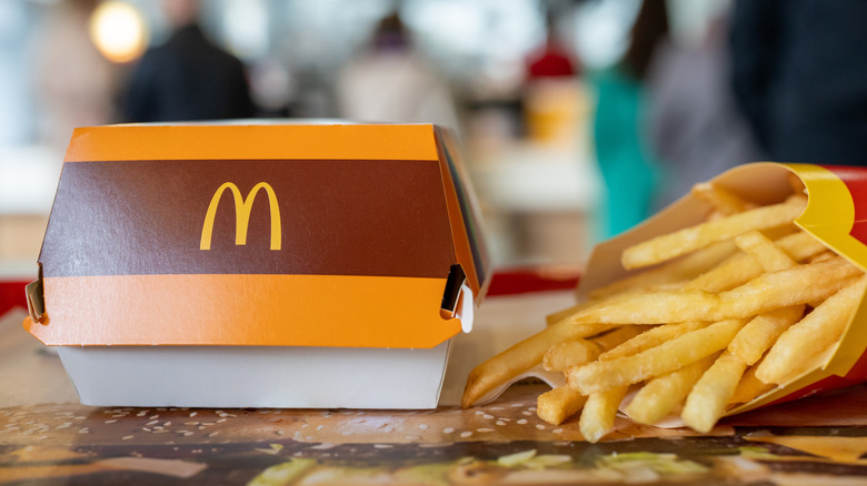 closeup of a McDonald's sandwich box and side order of fries on a tray