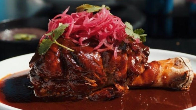 Pork shank in a demi-glaze white plate