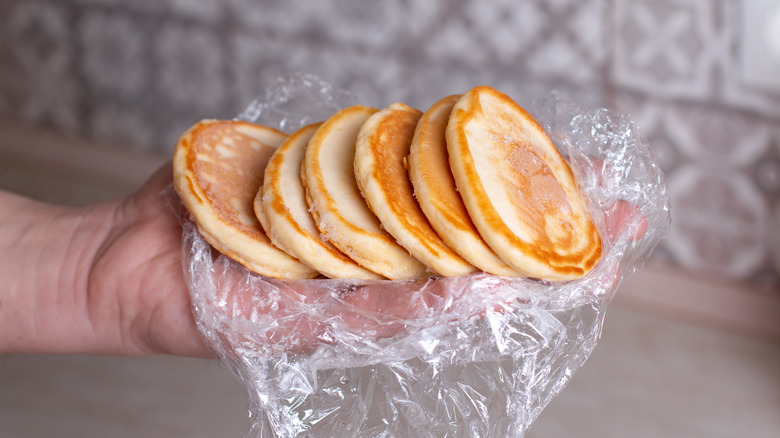 hand holding frozen pancakes