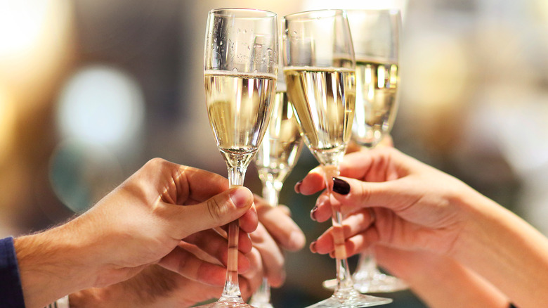Hands toasting champagne glasses