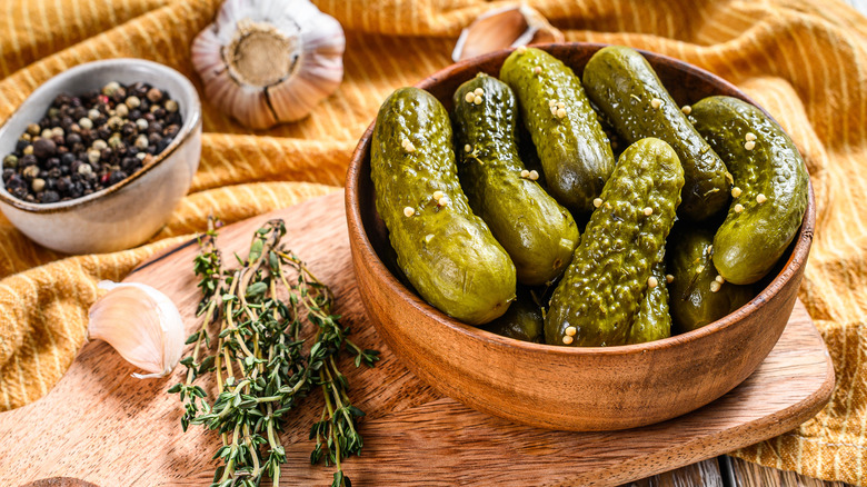 Pickles in a wooden bowl with spices 