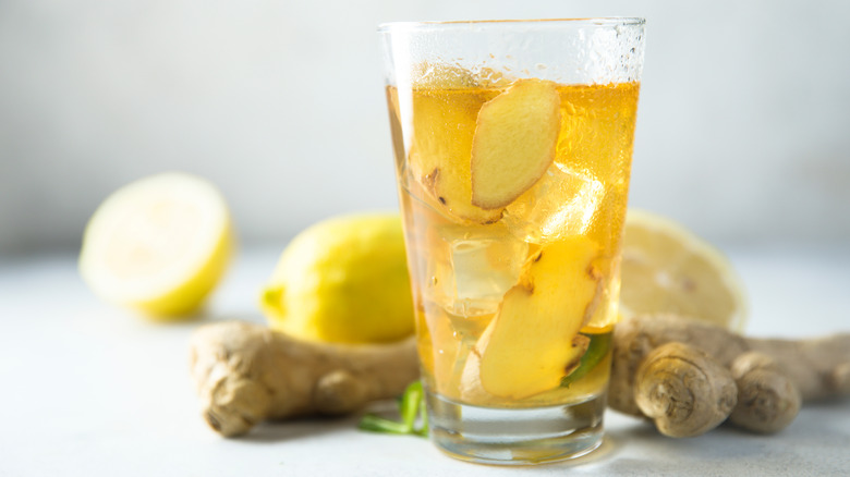 unpeeled ginger coins in glass of iced tea