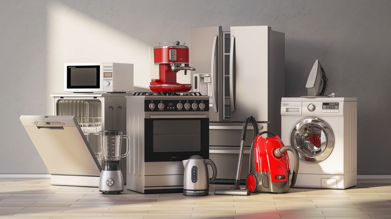 Variety of large and small kitchen and other appliances grouped together in a room