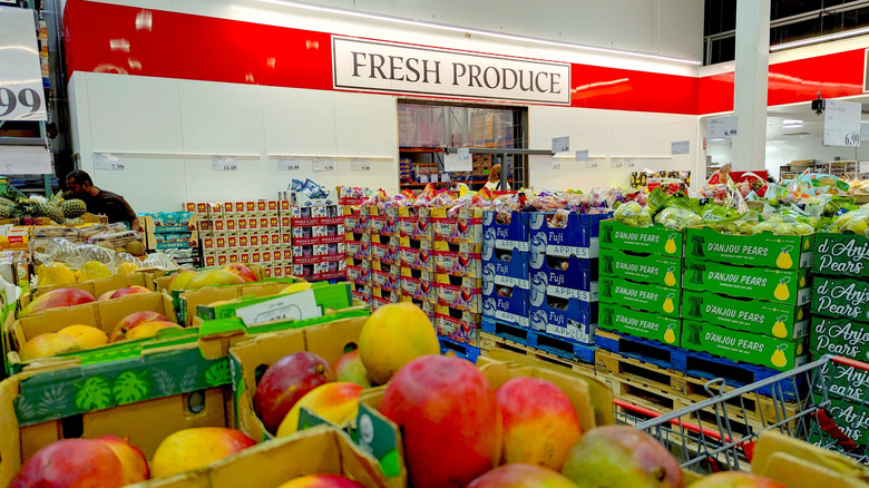 The fresh produce section at Costco with mangos, pears, and apples in view