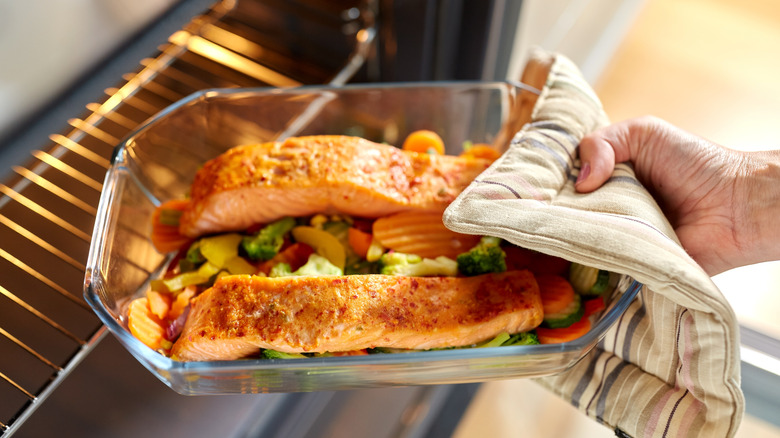 Salmon being pulled out of the oven