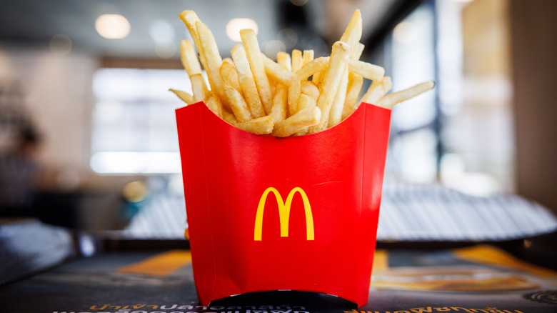 red McDonald's fries container on tray in restaurant