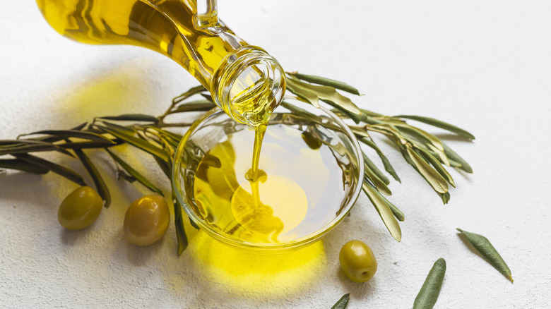 Olive oil being poured in bowl
