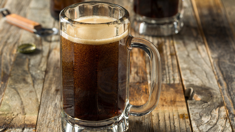 Cold refreshing root beer soda in a glass.