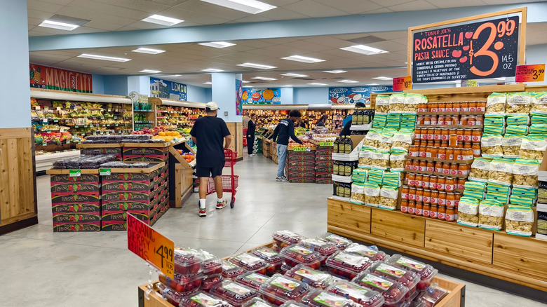 Interior of Trader Joe's store featuring pasta display and plums