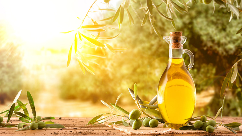 Olive oil surrounded by olives