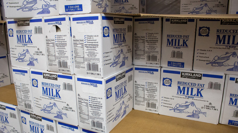 Stacked cartons of Kirkland reduced-fat milk
