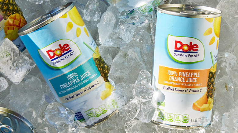 Cans of Dole pineapple slices on a shelf