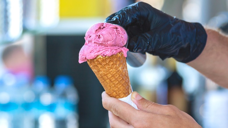 gloved hands scooping out dondurma
