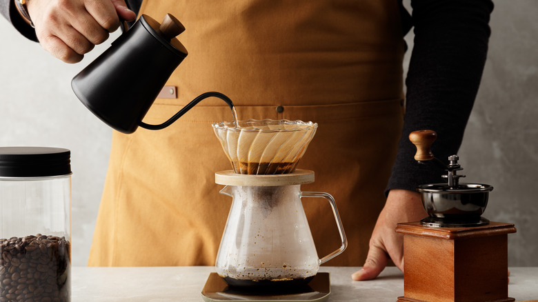 person making pour over coffee