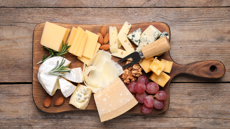 cheese, fruit and nuts on a board