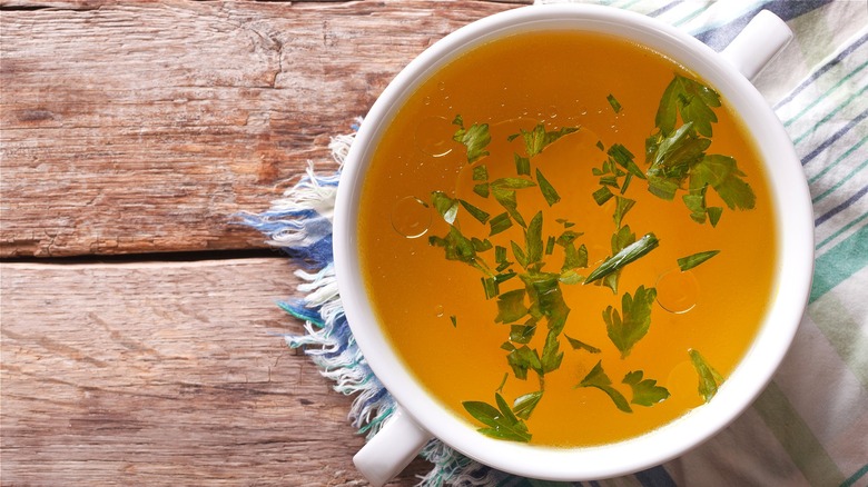 Chicken stock in white bowl 
