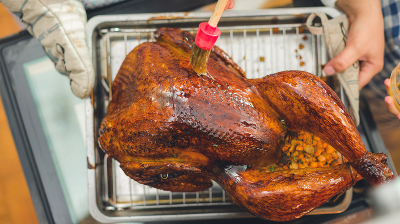 A roast turkey being basted