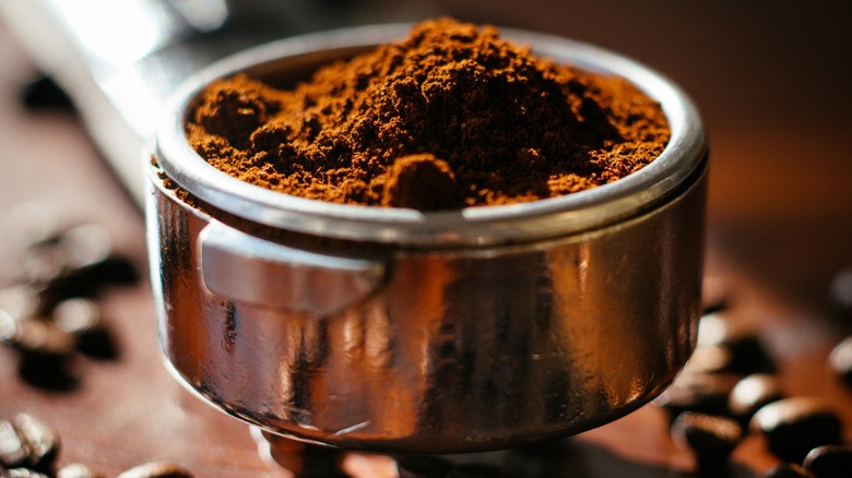 Coffee grounds in a metal scoop