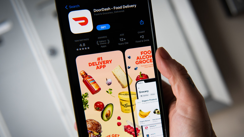 phone-user looking at DoorDash app