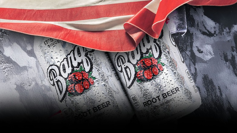 Cans of Barq's root beer next to the US flag