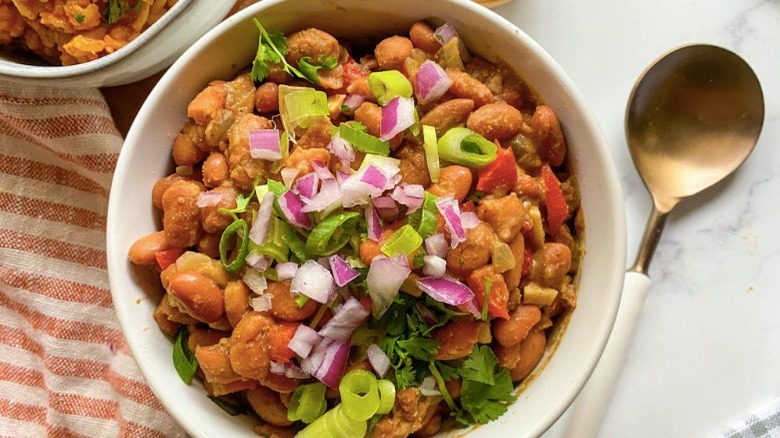 pinto beans with green onions as toppings