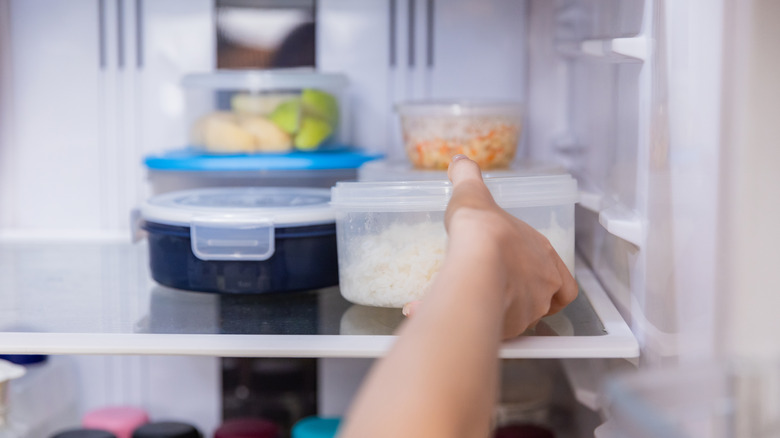 grabbing leftovers from fridge