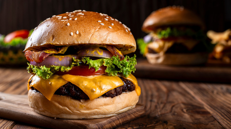 close-up shot of a gourmet homemade cheeseburger on a dark background