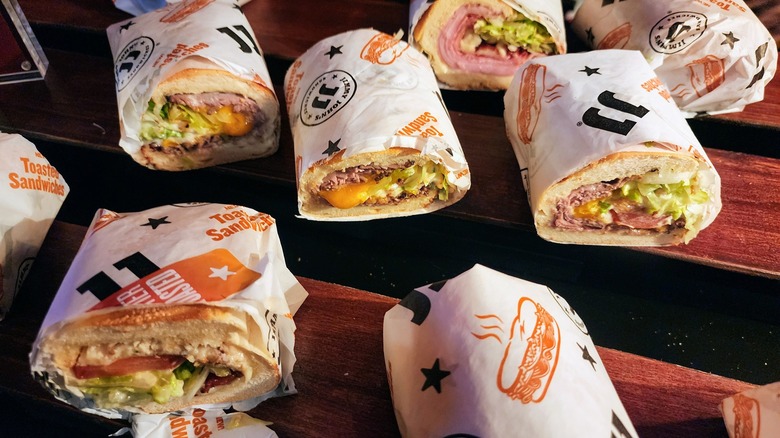 Jimmy John's toasted sandwiches on wooden table