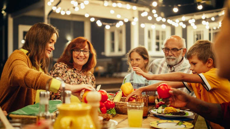 Outdoor dinner party under lights