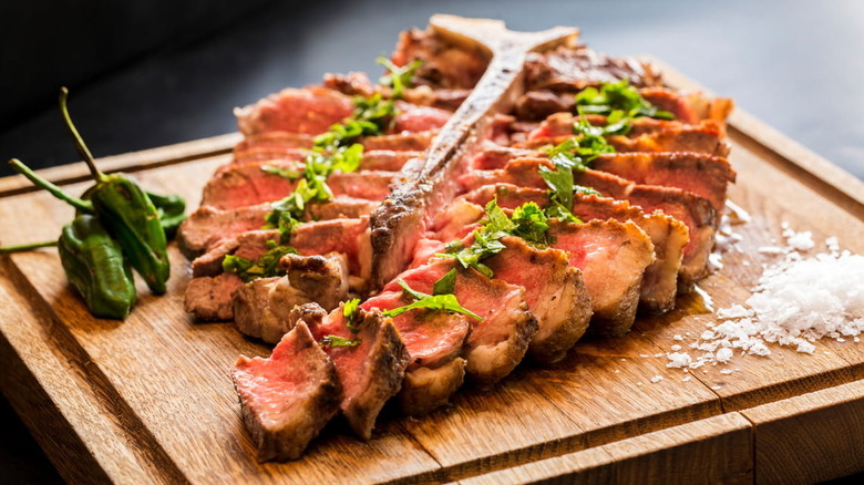 Sliced Porterhouse steak with jalapenos and shaved salt