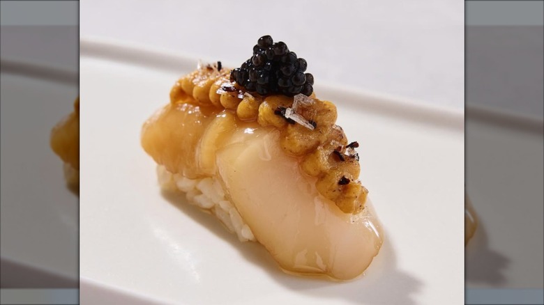A piece of sushi topped with caviar