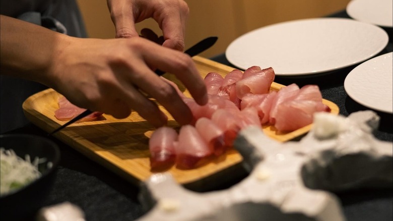 Chef plating sashimi