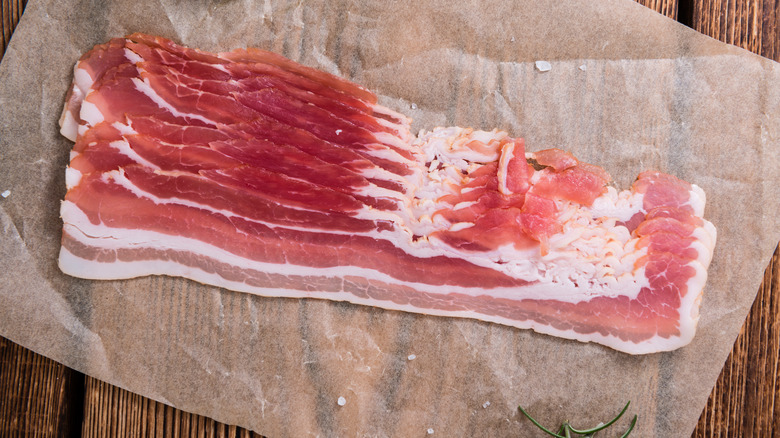 raw bacon on parchment paper