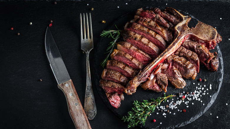 Carved Bistecca Alla Fiorentina on black slate