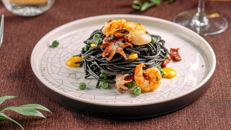 White plate of Spaghetti Al Nero di Seppia with seafood