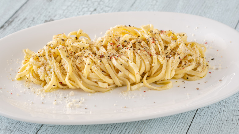 Portion of cacio e pepe on white oval platter