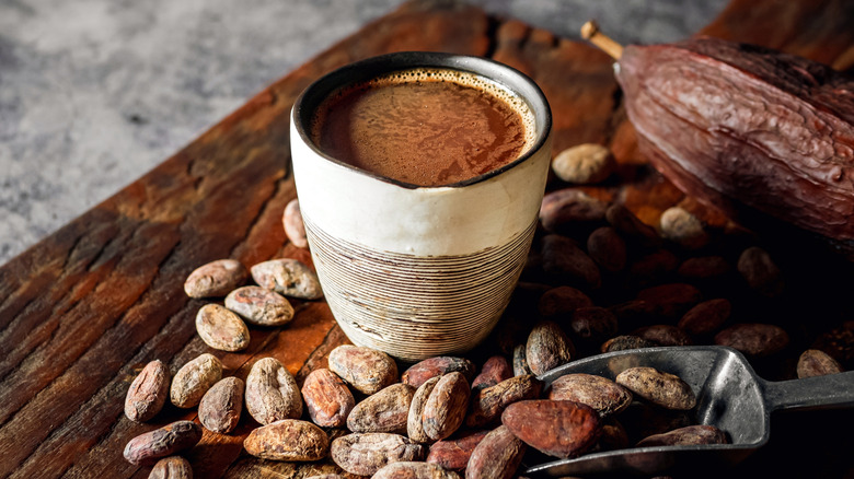 Cup of hot chocolate and cocoa beans