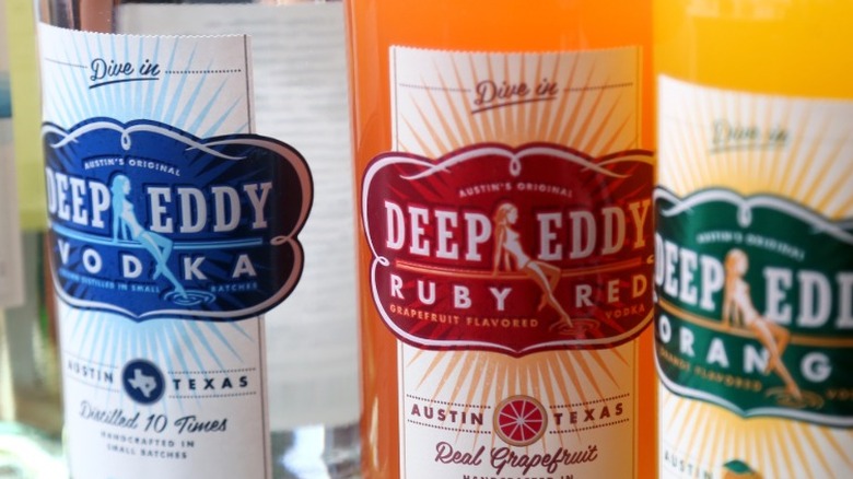 A closeup of Deep Eddy vodka bottles, including the Real Grapefruit and Orange flavor