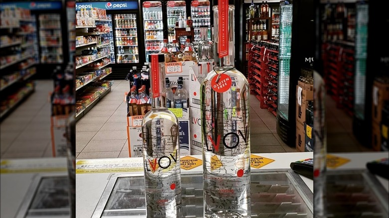 Two LVOV Vodka bottles sitting on a counter in a liquor store