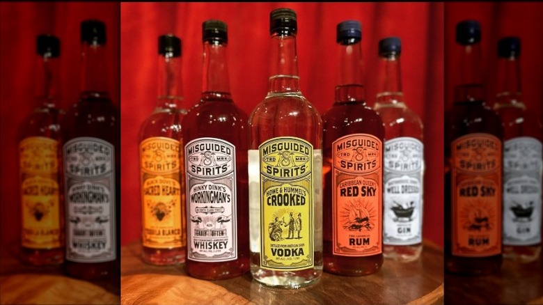 A lineup of Misguided Spirits products, including tequila, whiskey, vodka, rum, and fin
