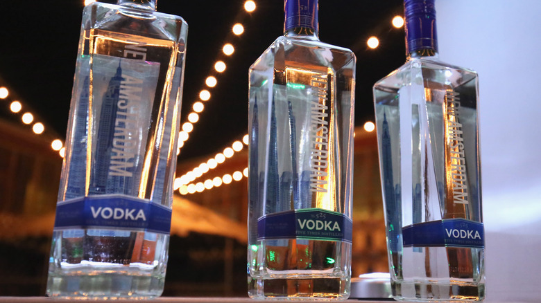 A closeup of three New Amsterdam vodka bottles